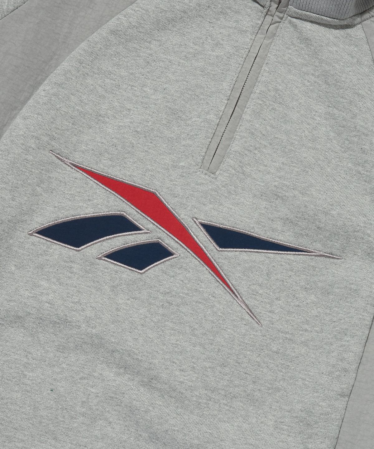 리복(REEBOK) 뉴벡터 하이브리드 하프 집업 - 그레이