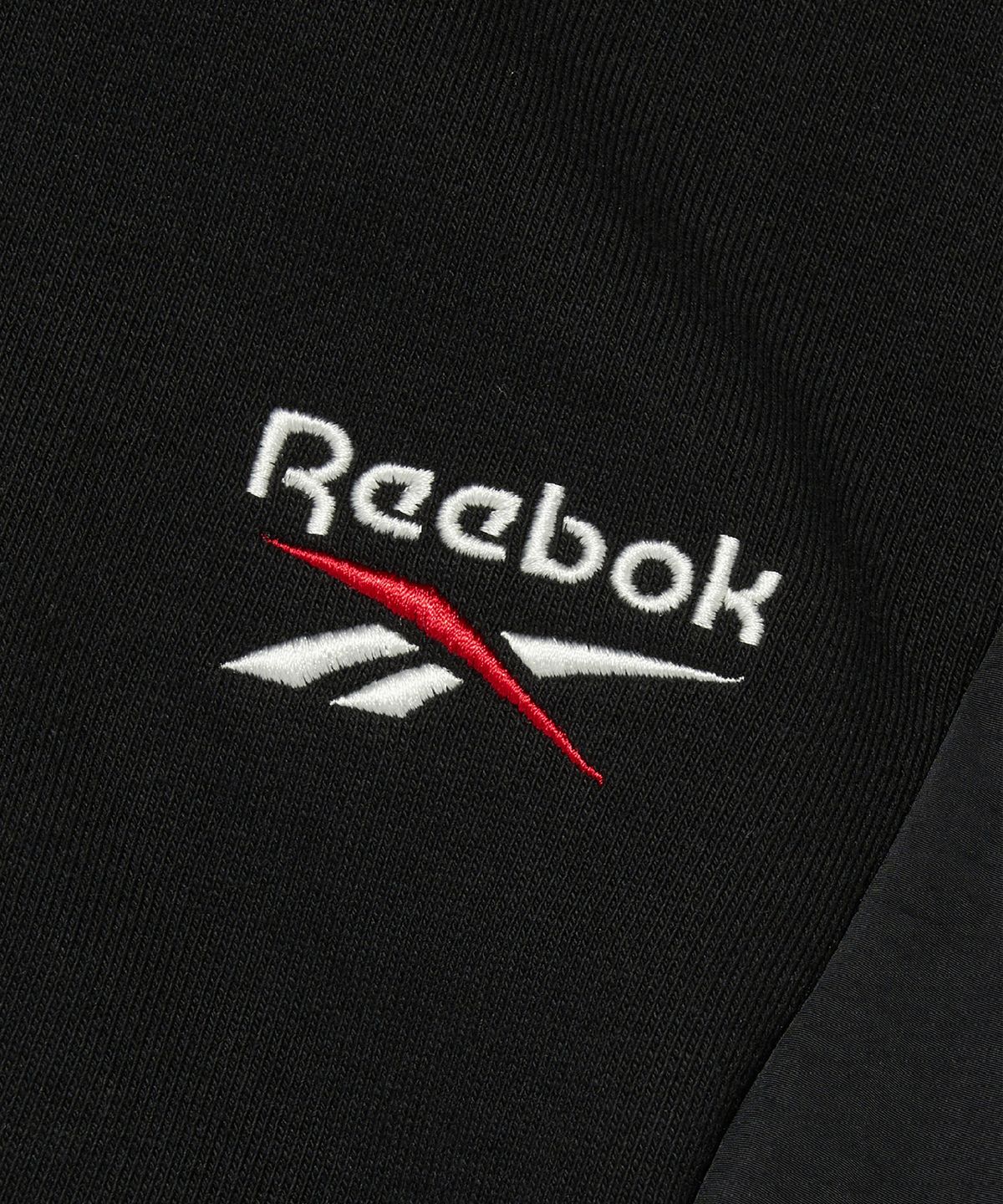리복(REEBOK) 뉴벡터 하이브리드 후드집업 - 블랙