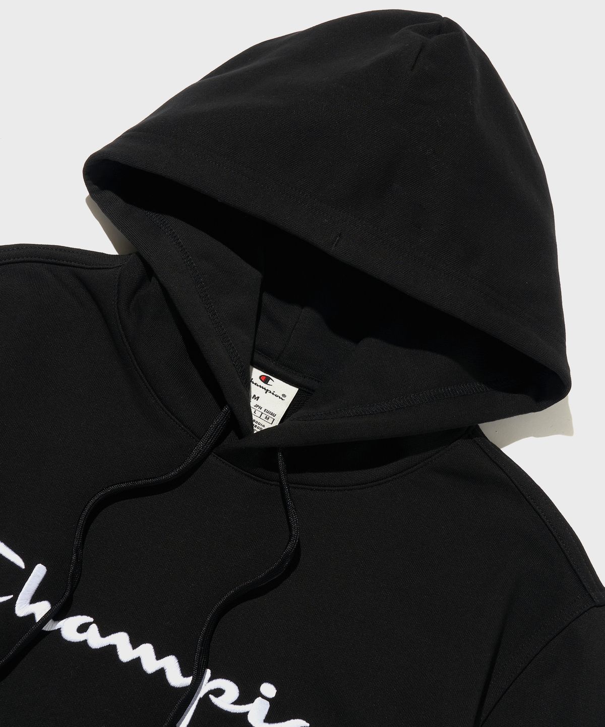 챔피온(CHAMPION) 빅 스크립트 로고 후드 티셔츠 Black