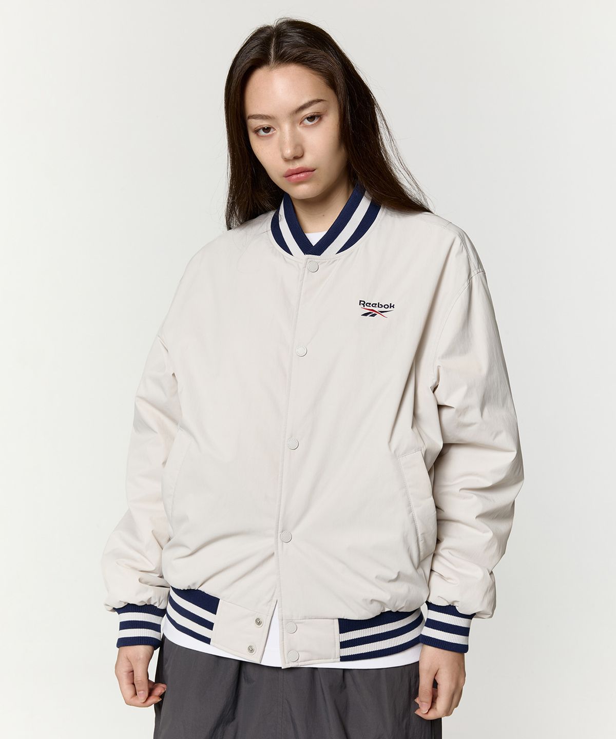 리복(REEBOK) 뉴베이직 바시티 자켓 - 베이지