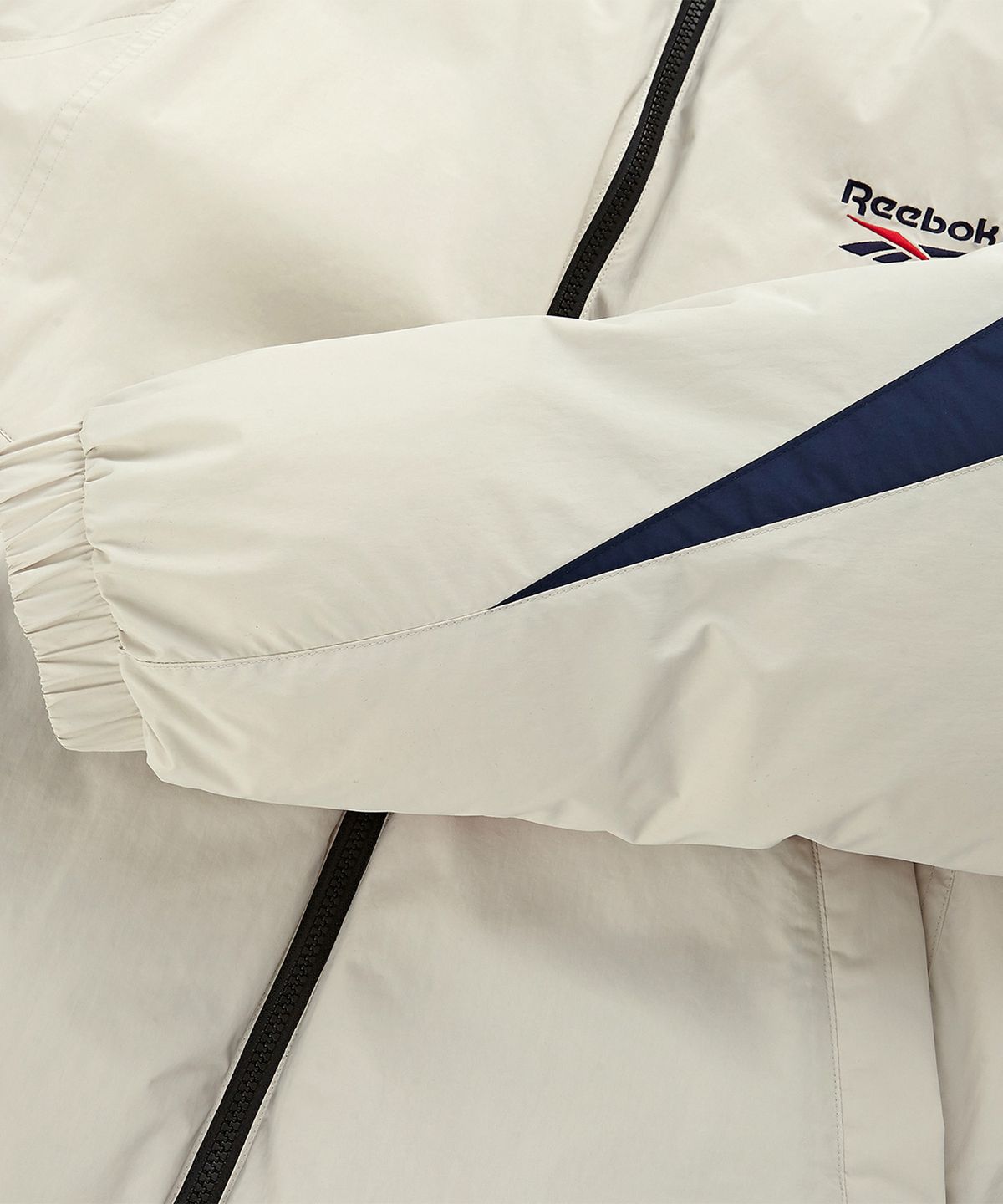 리복(REEBOK) 벡터 리버시블 다운 자켓 - 베이지