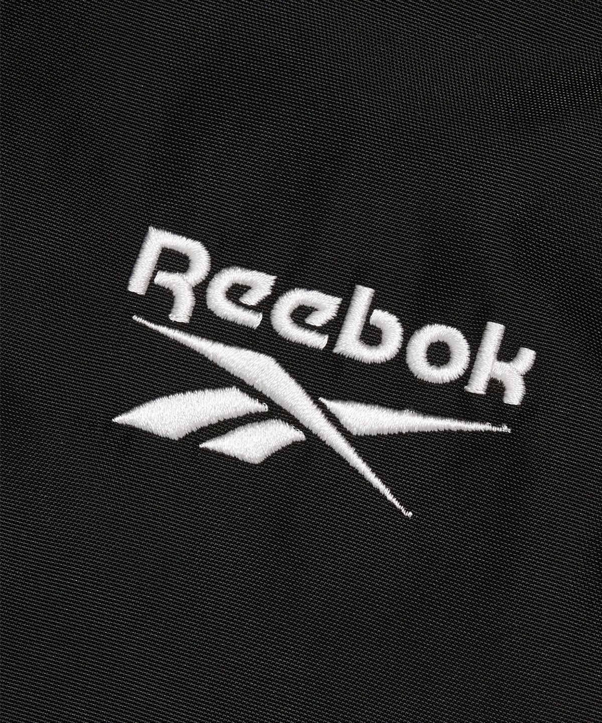 리복(REEBOK) 벡터 패널드 벤치 코트 - 블랙
