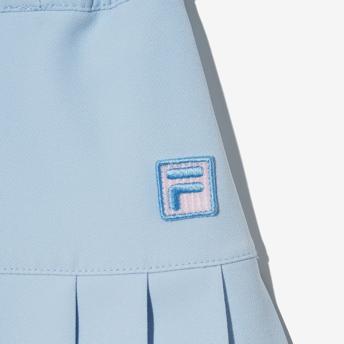 휠라 키즈(FILA KIDS) 밑단 테이프 플리츠 스커트