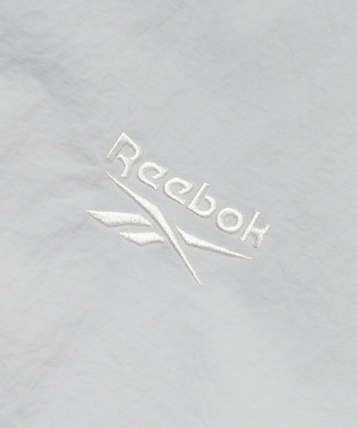 리복(REEBOK) 에센셜 웜업 윈드 브레이커 - 라이트 그레이