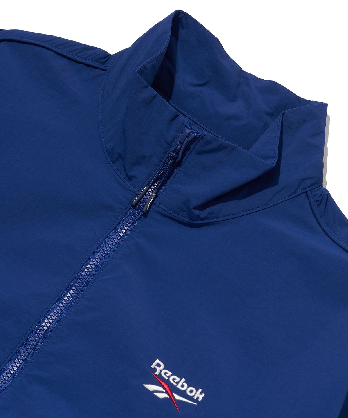 리복(REEBOK) 에센셜 웜업 윈드 브레이커 - 블루