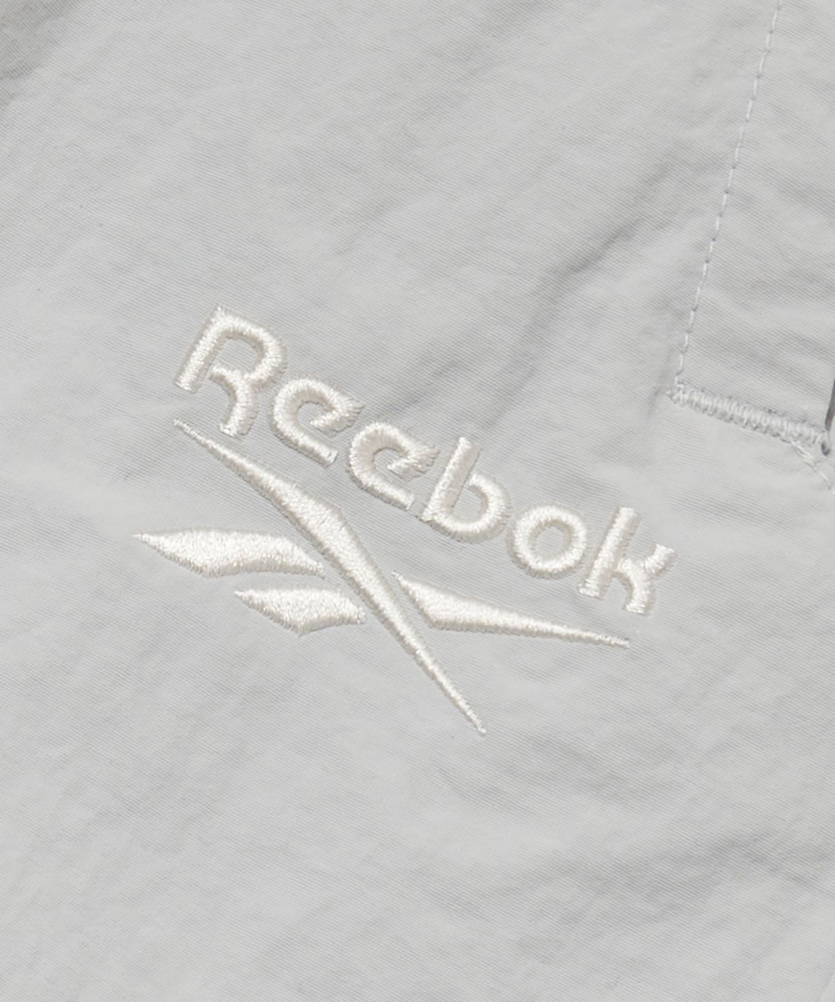 리복(REEBOK) 에센셜 2WAY 웜업 팬츠 - 라이트 그레이