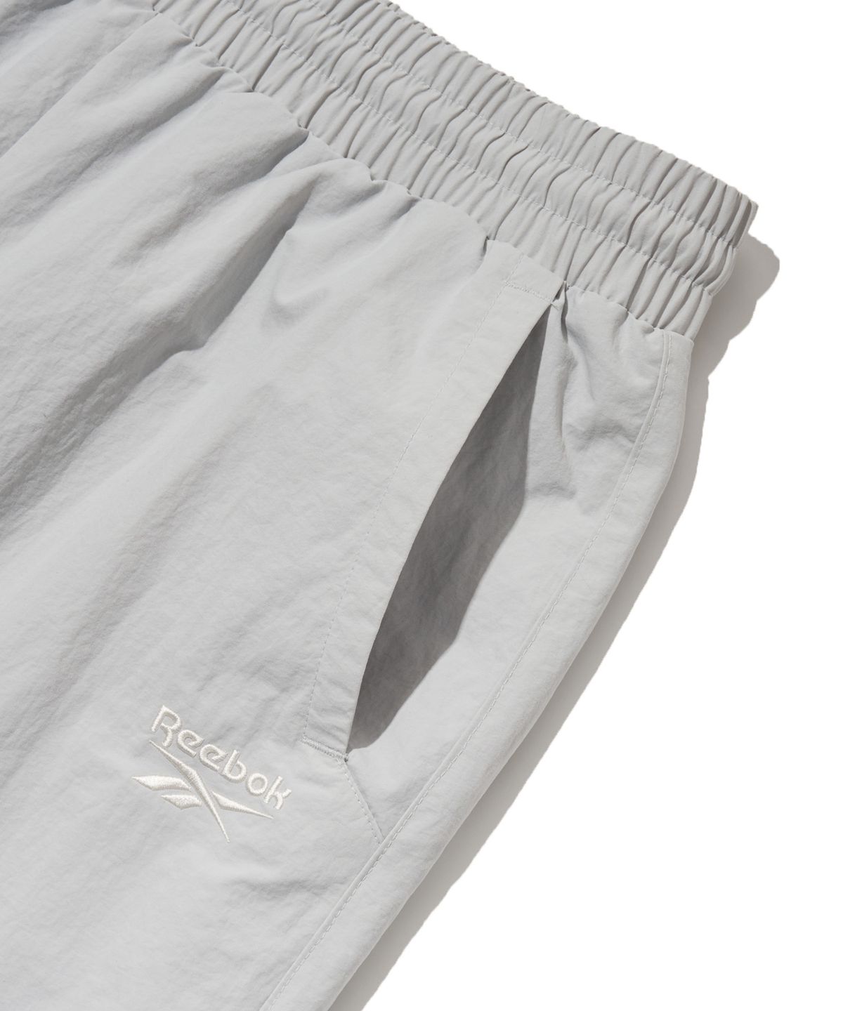 리복(REEBOK) 에센셜 2WAY 웜업 팬츠 - 라이트 그레이