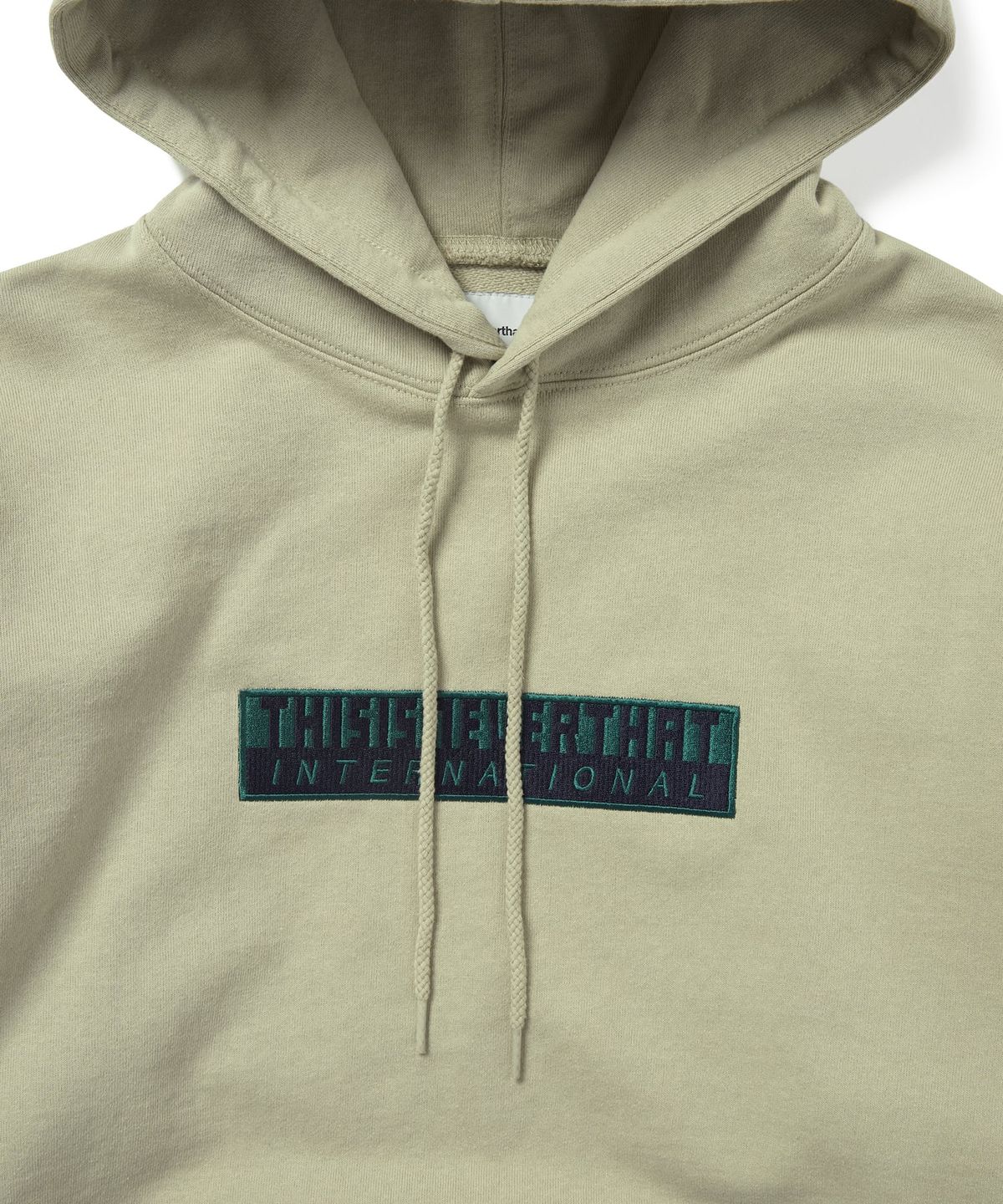 디스이즈네버댓(THISISNEVERTHAT) TNT International Hoodie Stone