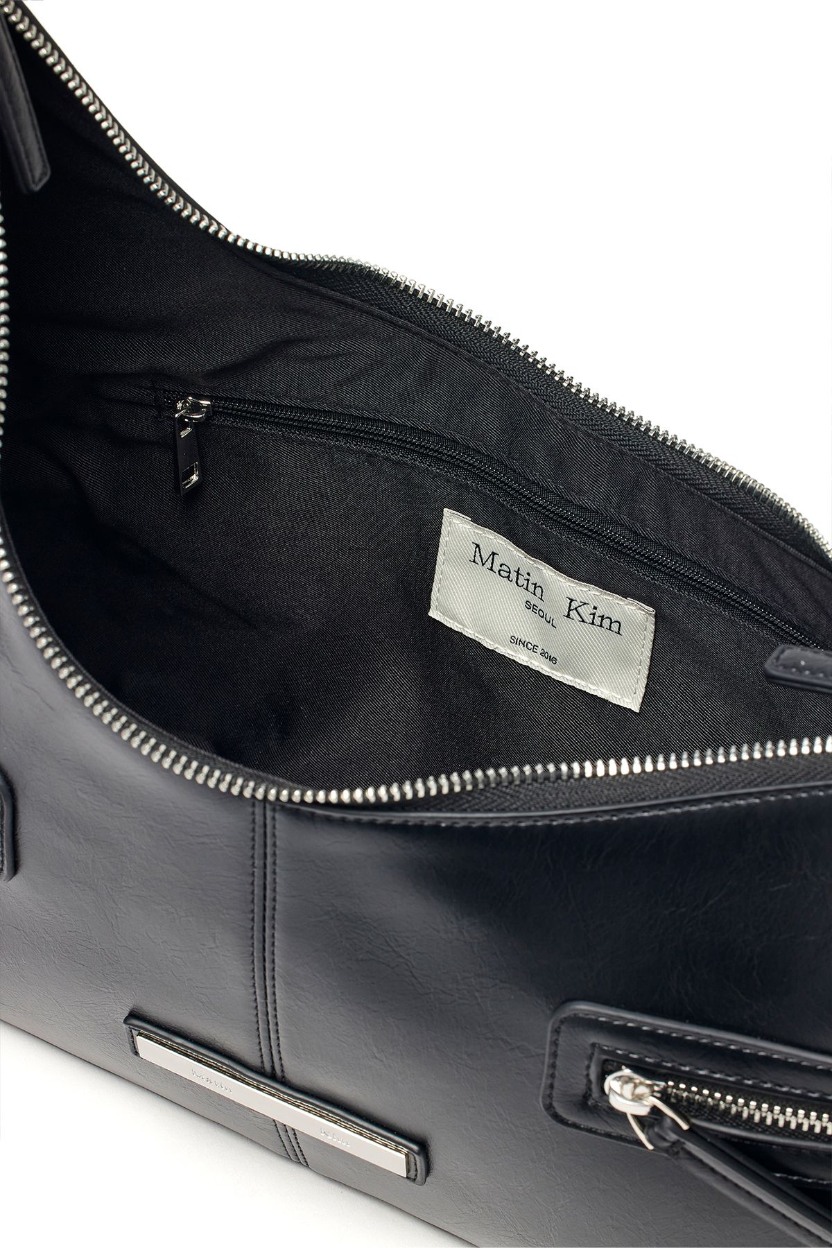 MUSINSA | MATIN KIM ASYMMETRICAL ZIPPER BAG IN BLACK