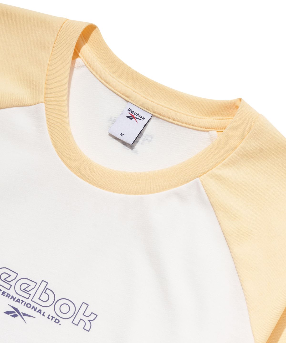 리복(REEBOK) 프린트 래글런 티셔츠 (W) - 버터