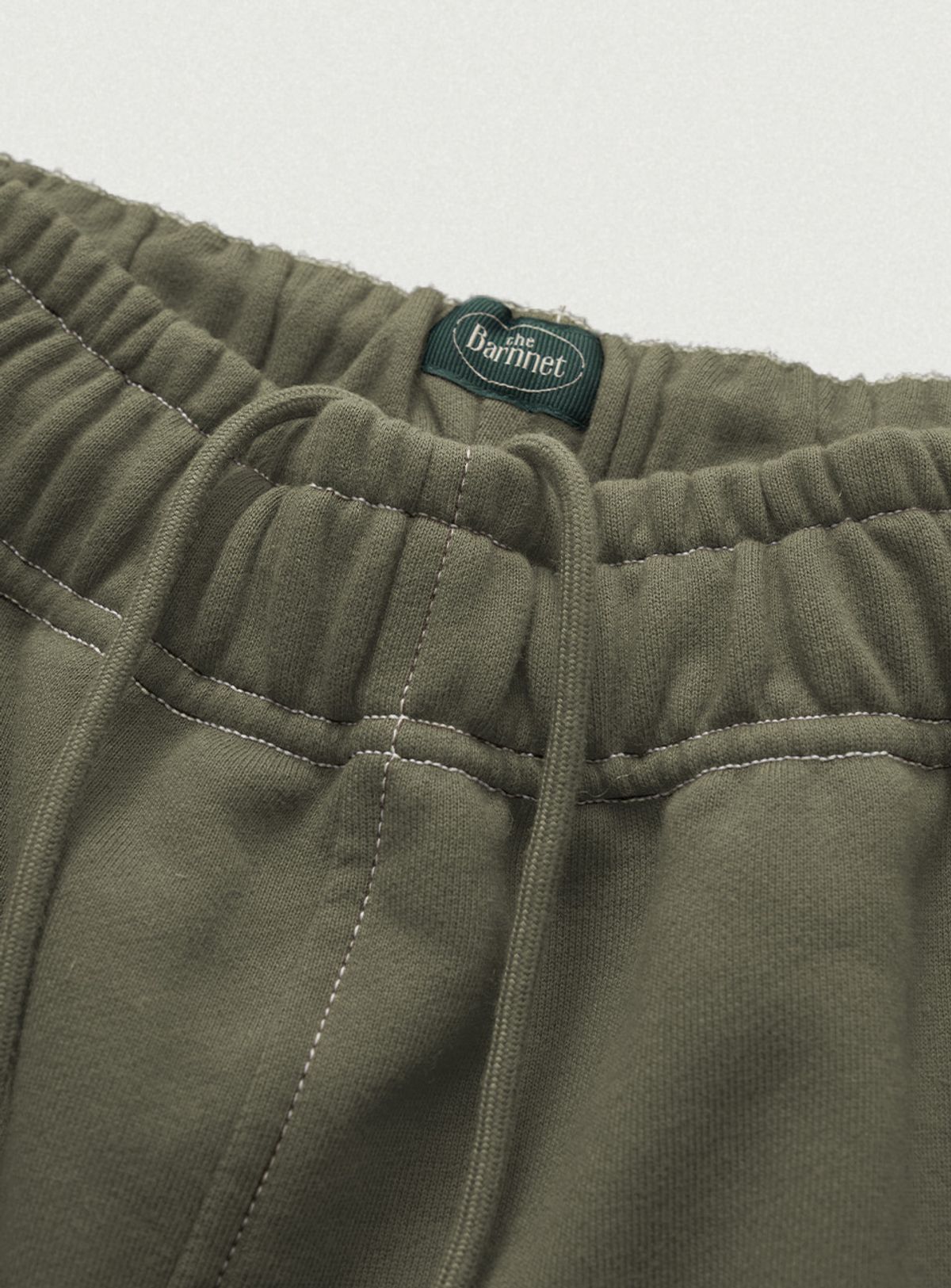 더바넷(THEBARNNET) Campie Sweat Drawstring Jogger Pants_Khaki