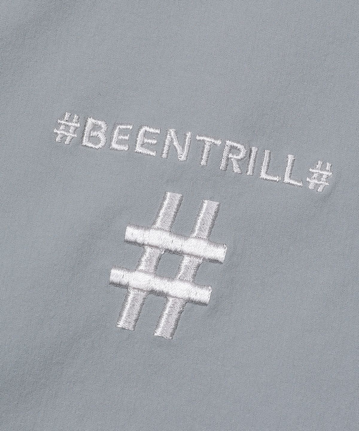 빈트릴(BEENTRILL) 스프레이 로고 우븐 점퍼(라이트 카키)