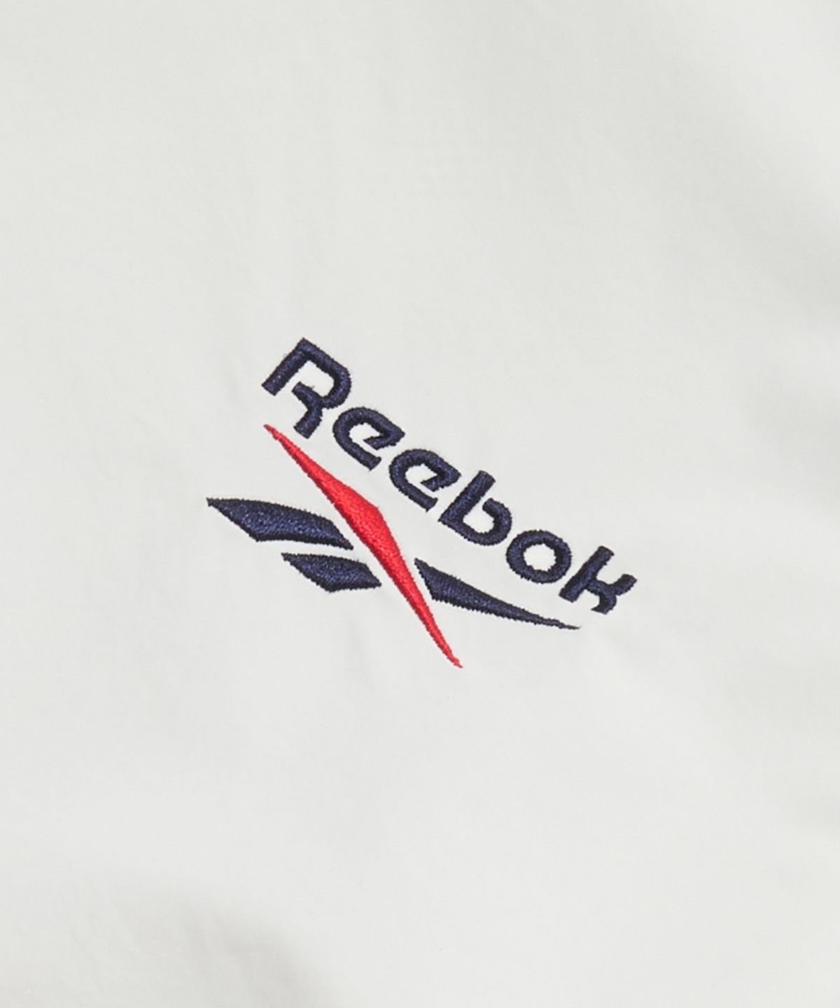 리복(REEBOK) 일립스 크롭 윈드 브레이커 (W) - 화이트:네이비