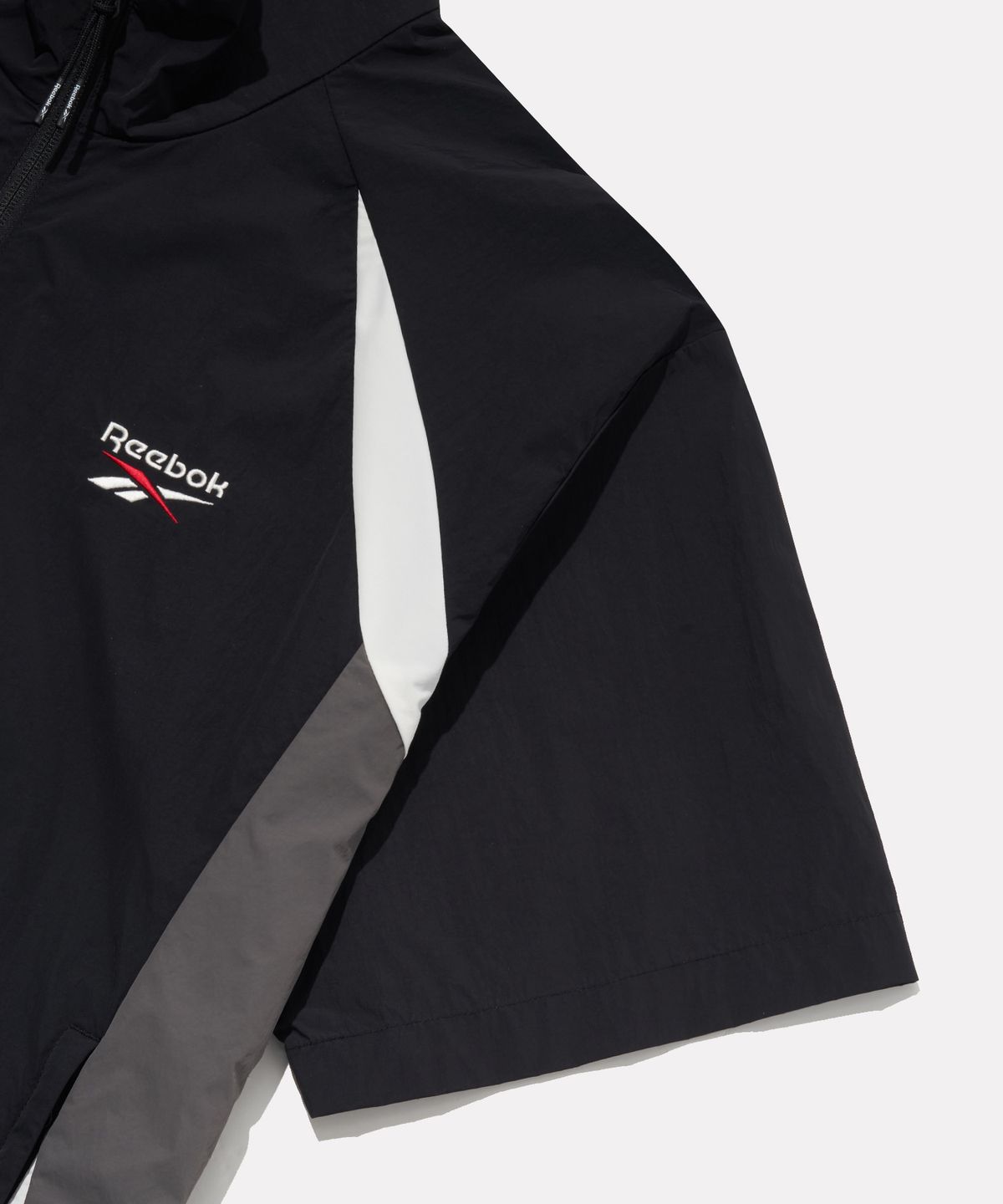 리복(REEBOK) 일립스 반팔 아노락 - 블랙