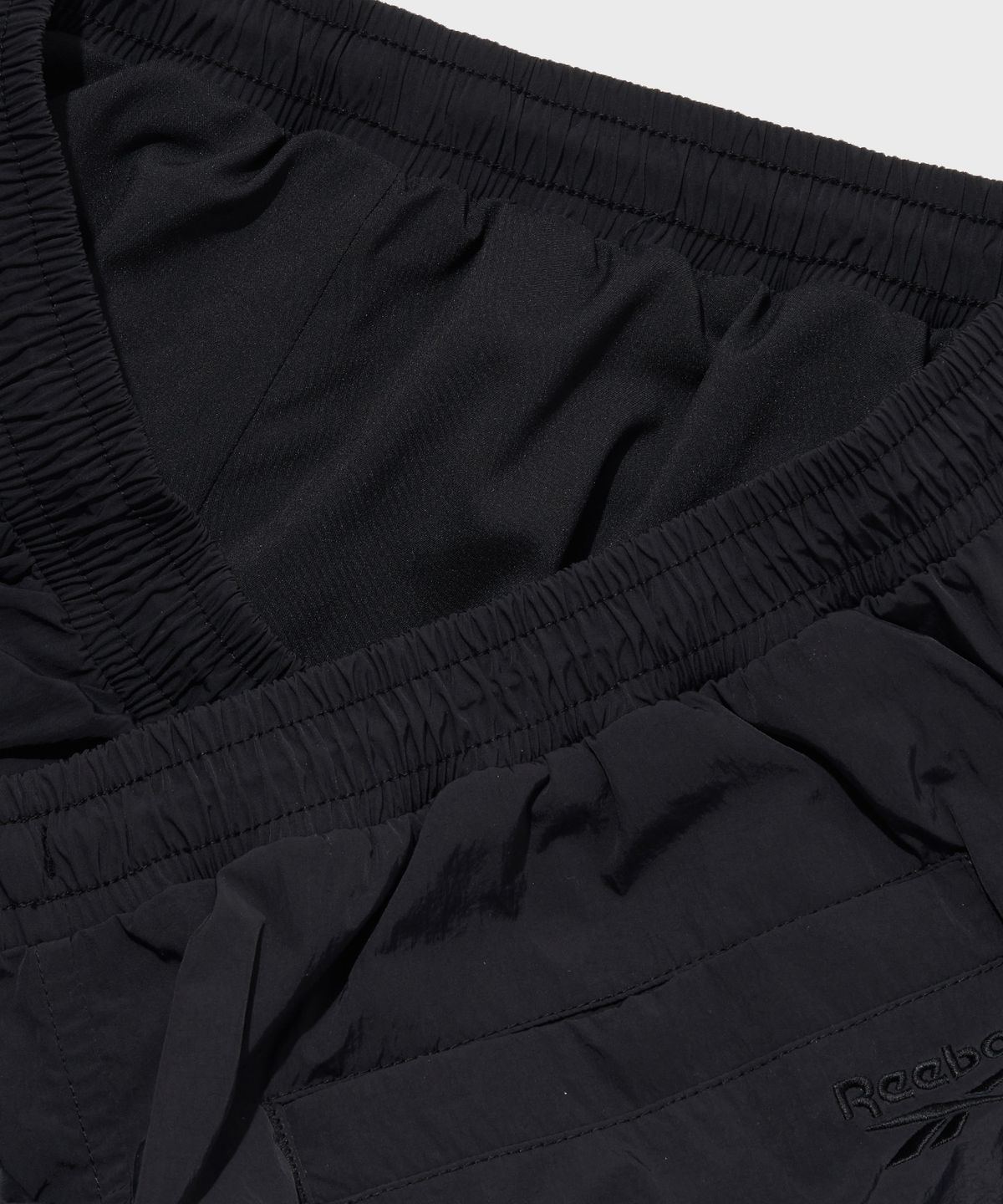 리복(REEBOK) 일립스 파라슈트 스커트 (W) - 블랙