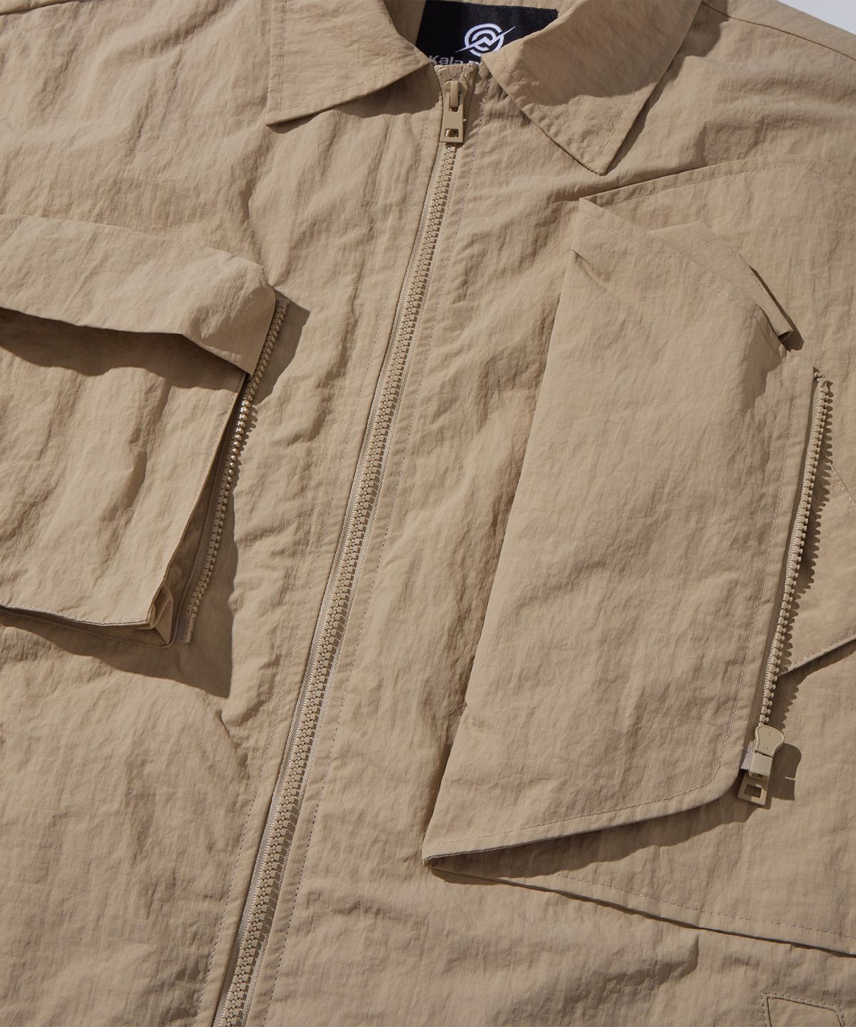 칼라파타르(KALAPATTHAR) Nylon Taslan Offset Zip Pocket Half Shirts - Beige