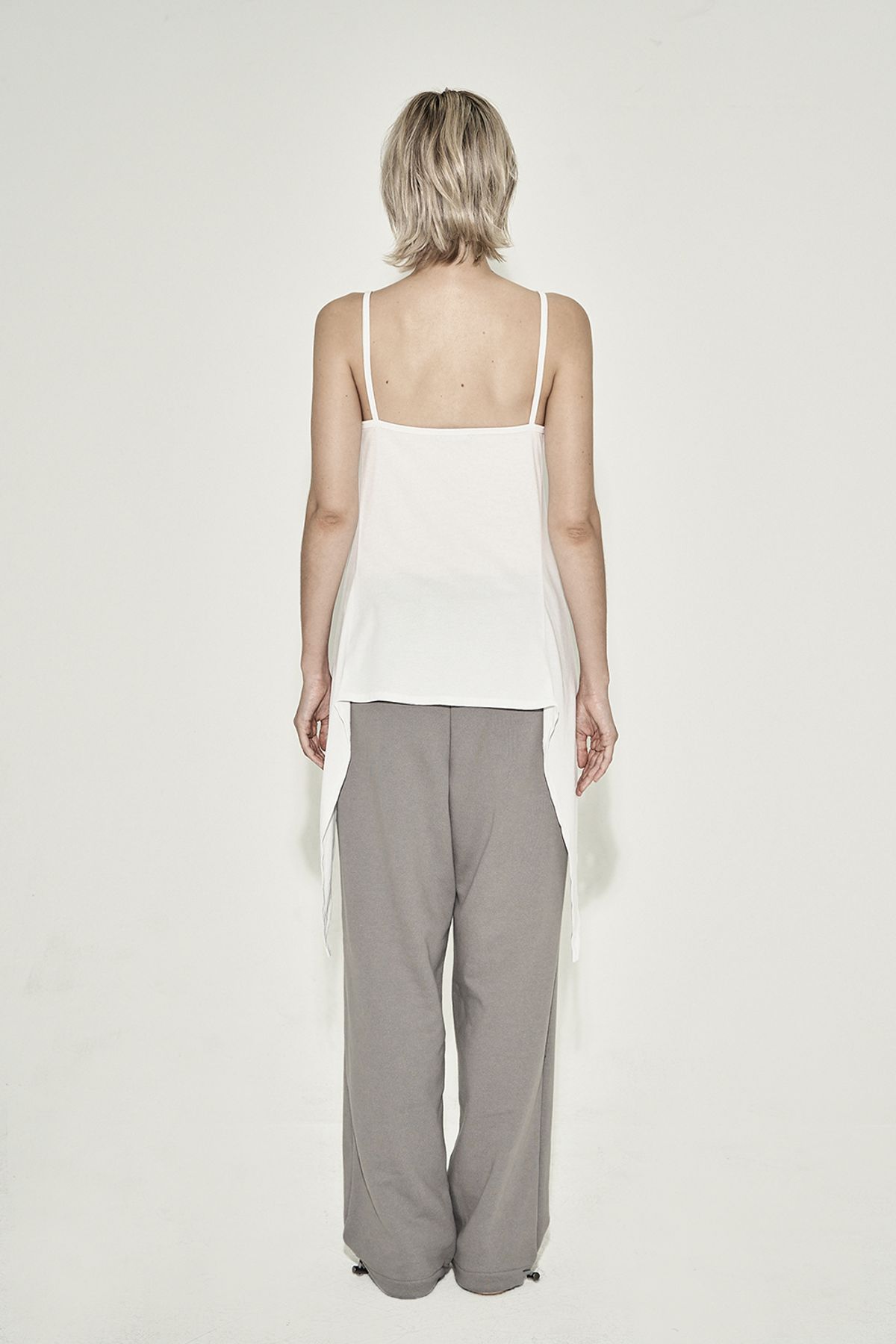 시너진(SYNERJYN) TWISTED SLIT SLEEVELESS TOP WHITE