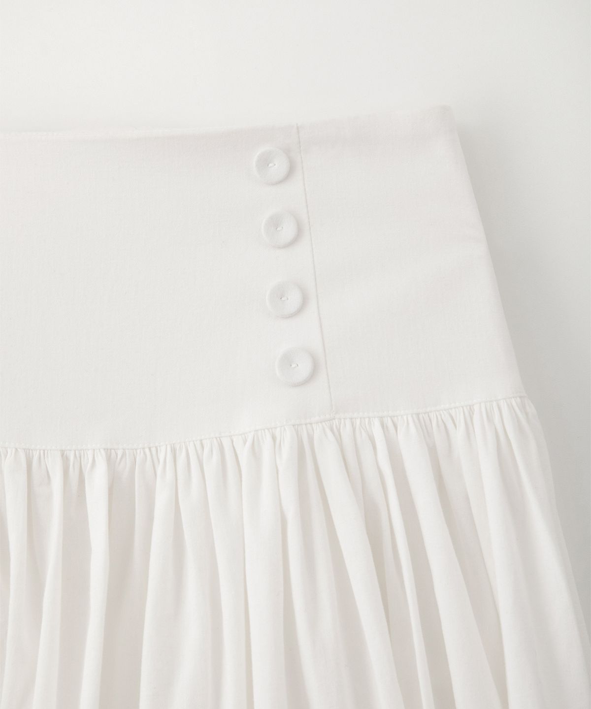 썸웨어버터(SOMEWHEREBUTTER) Button Shirring Long Skirt - Ivory