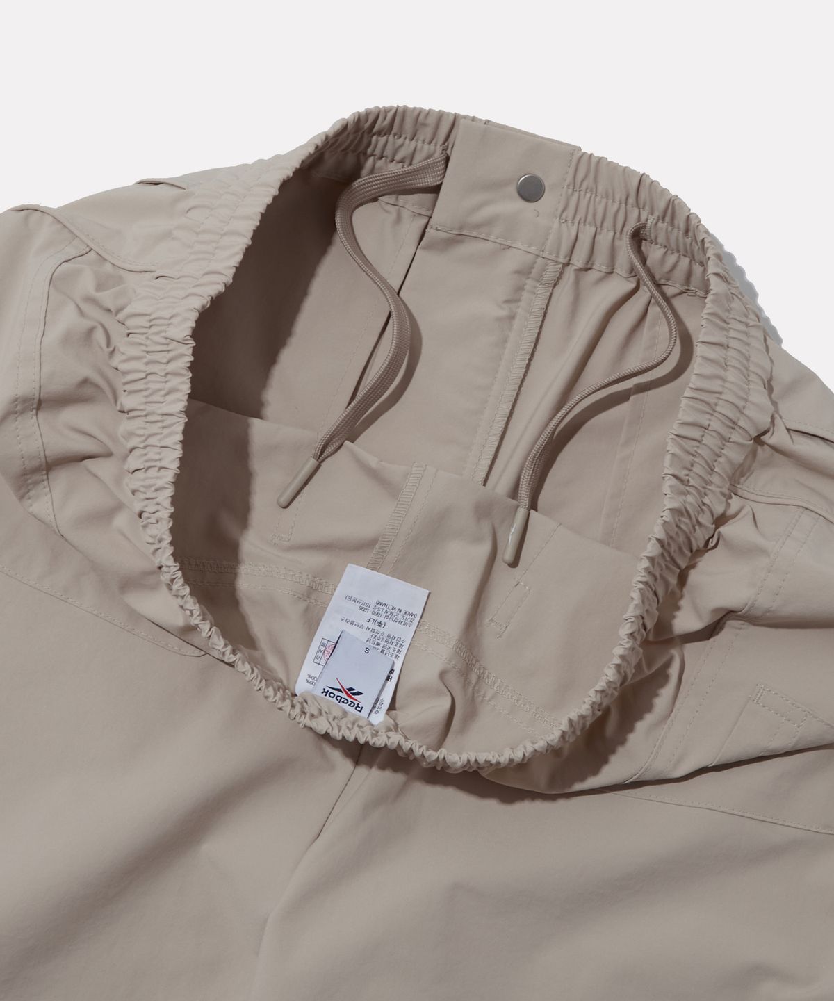 리복(REEBOK) 멀티 포켓 카고 팬츠 (W) - 아이보리