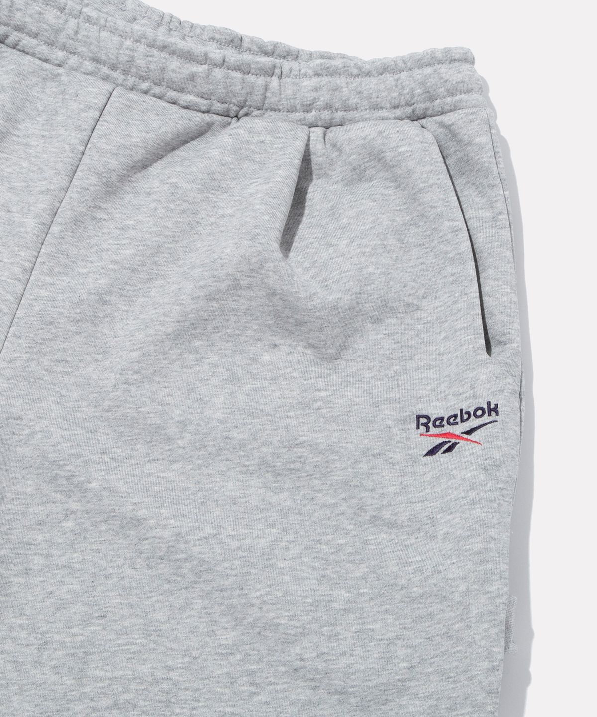 리복(REEBOK) 스웨트 버뮤다 쇼츠 - 그레이