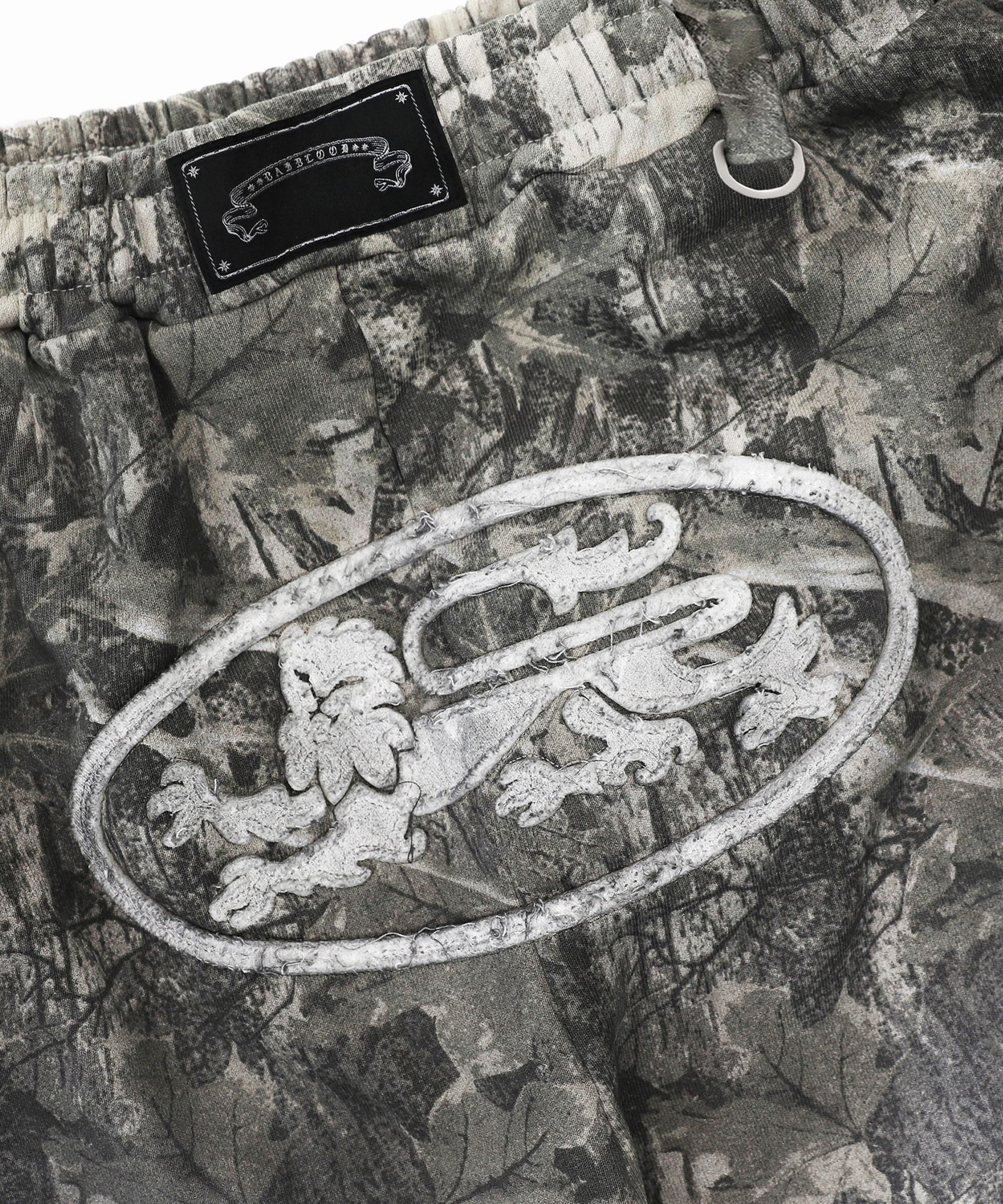 MUSINSA | BADBLOOD Lion Patch 2 Way Curved Jogger - Light Realtree