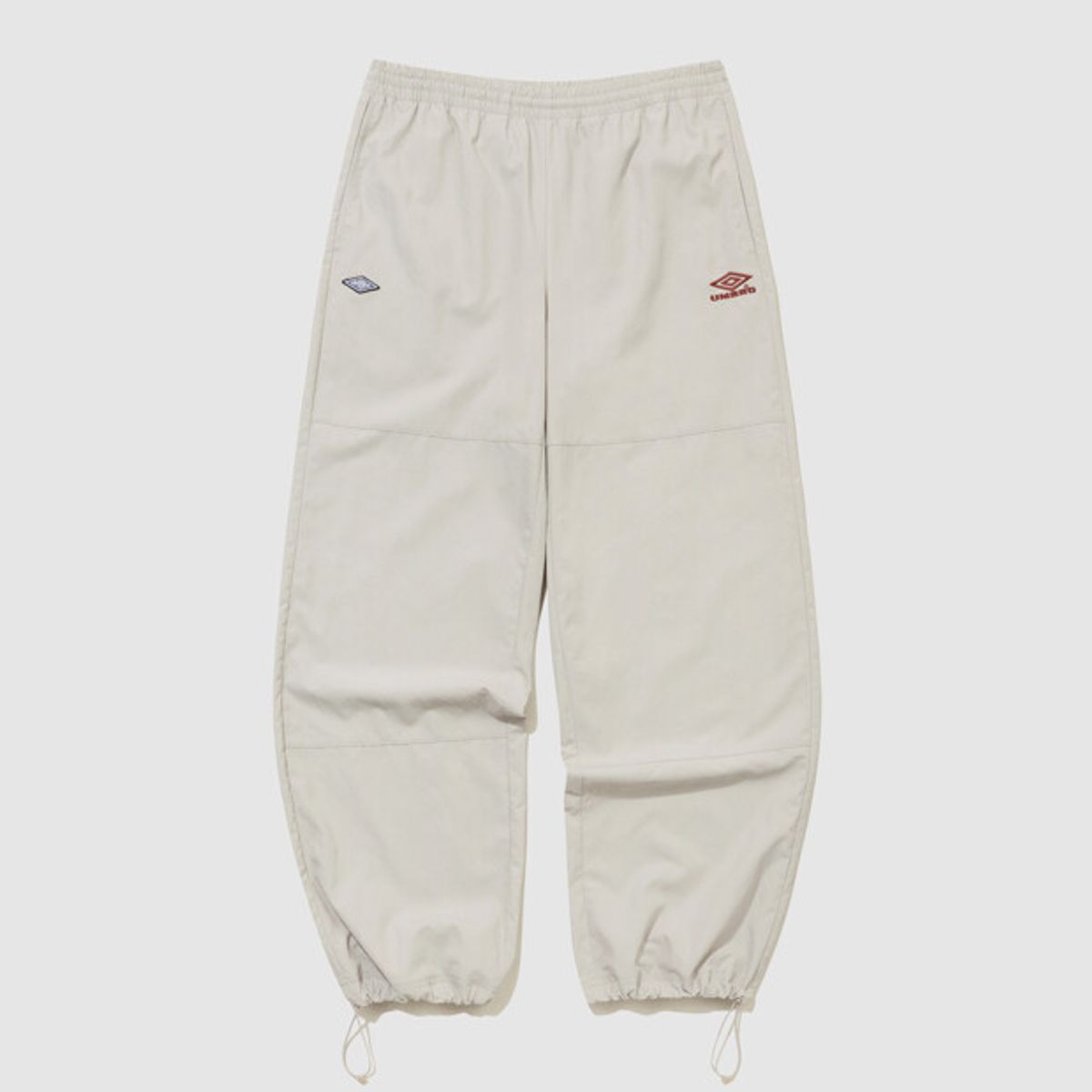 엄브로(UMBRO) HBL 로얄 컬리지 와이드 & 조거 2WAY 우븐 팬츠 베이지(UQ321CPT99)