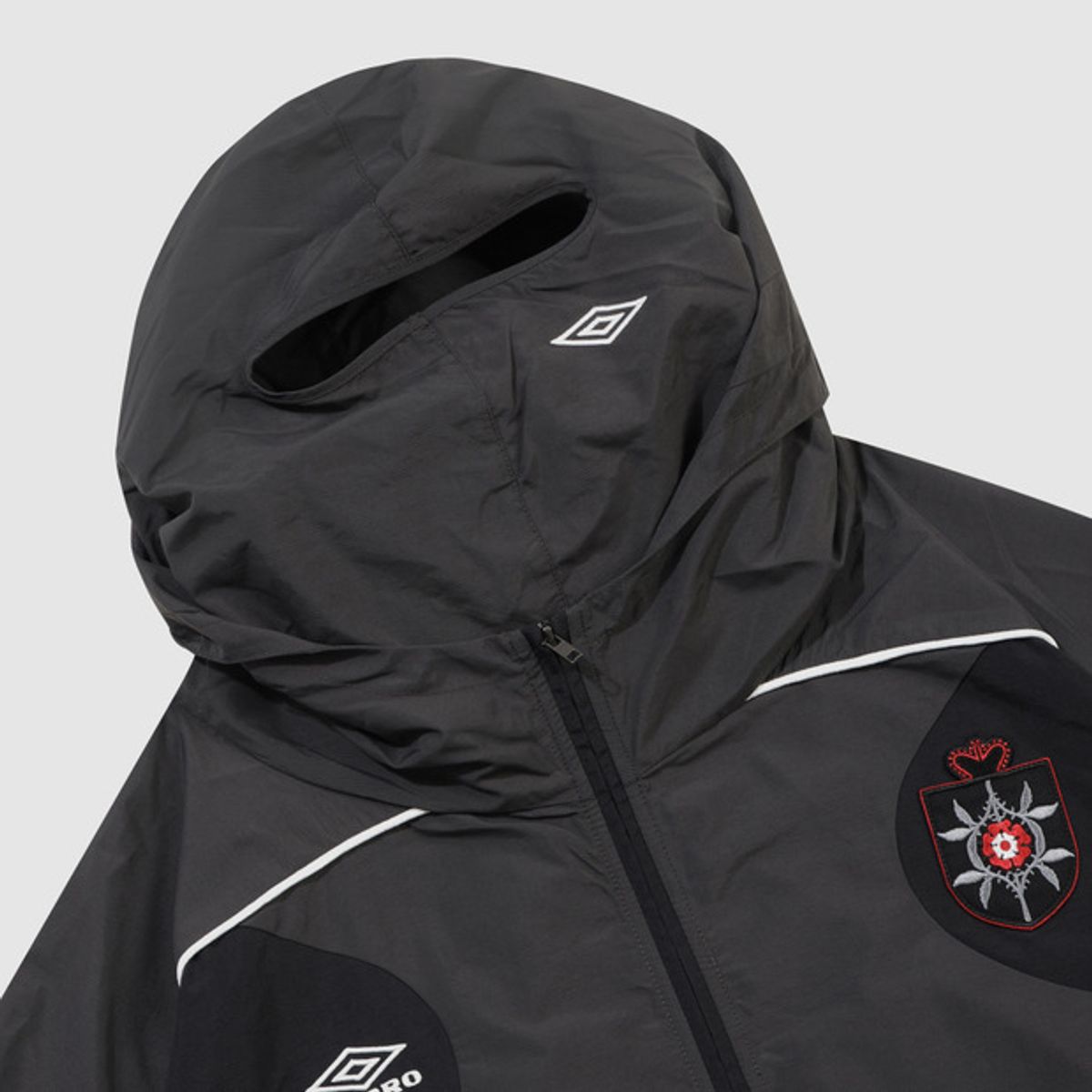 엄브로(UMBRO) [UMBRO X SLAM JAM] Rose Crest 마스크 자켓 블랙 UQ411CJKO2