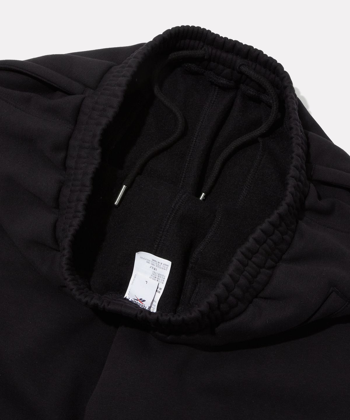 리복(REEBOK) 와이드핏 기모 스웻팬츠 - 블랙