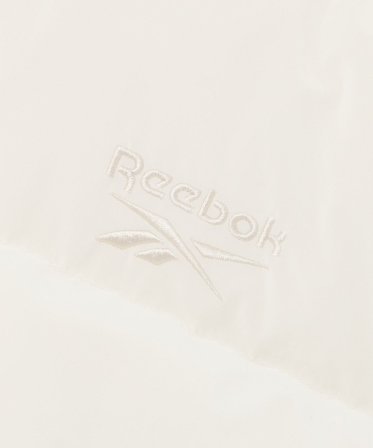 리복(REEBOK) 소프트 크롭 후드 볼패딩 (W) - 페일 베이지