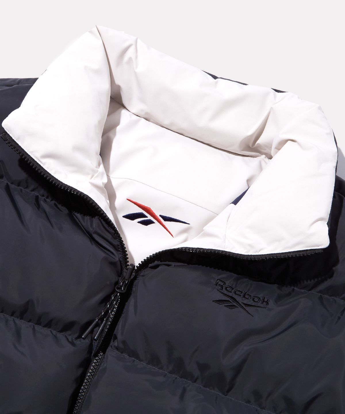 리복(REEBOK) 벡터 리버시블 볼패딩 - 페일베이지:차콜