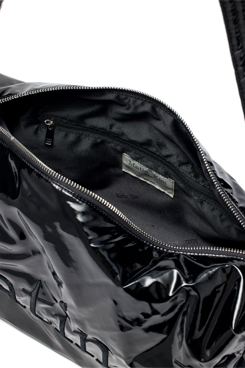 MUSINSA | MATIN KIM GLOSSY LOGO STITCH CROSS BAG IN BLACK