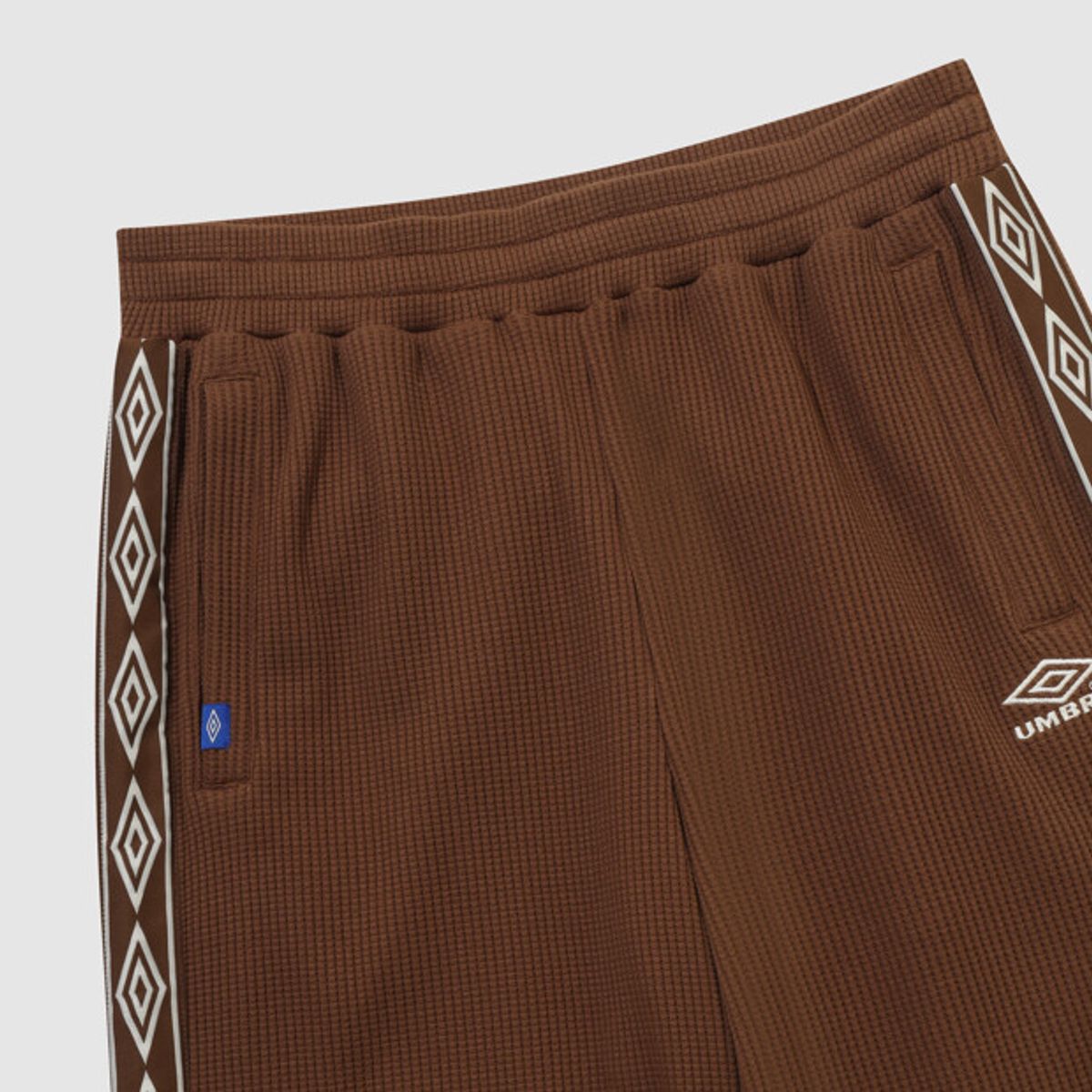 엄브로(UMBRO) 와플 와이드 조거 2WAY 트랙 팬츠 브라운 UR123CFP11