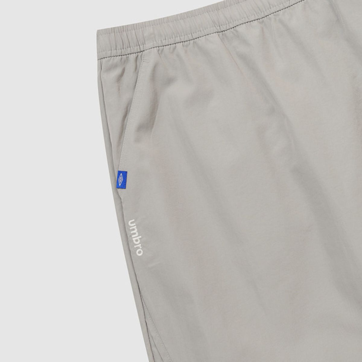 엄브로(UMBRO) 우먼스 트랙 우븐 롱스커트 베이지 UR122CSK11