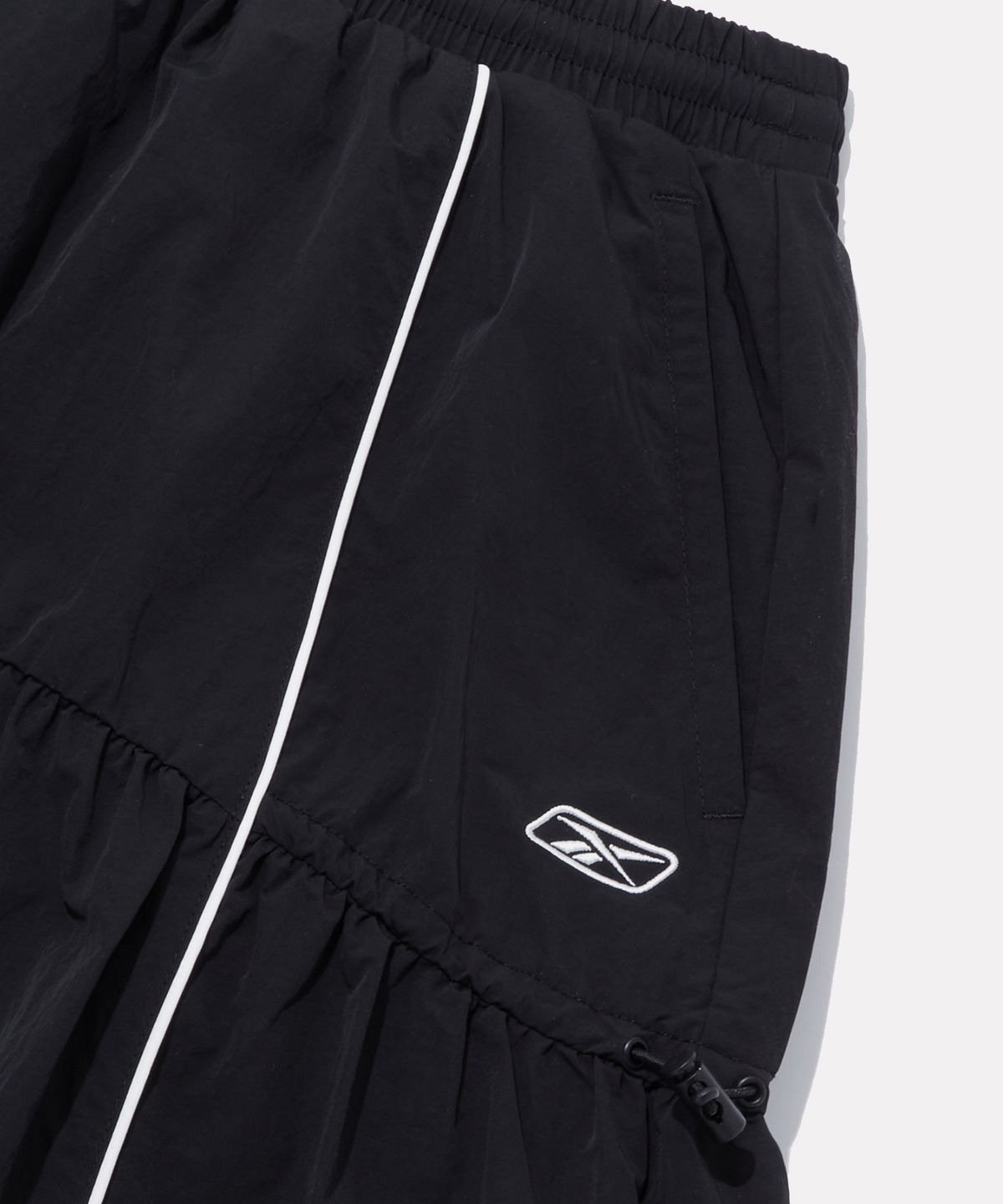 리복(REEBOK) 플레어 스트링 스커트 (W) - 블랙