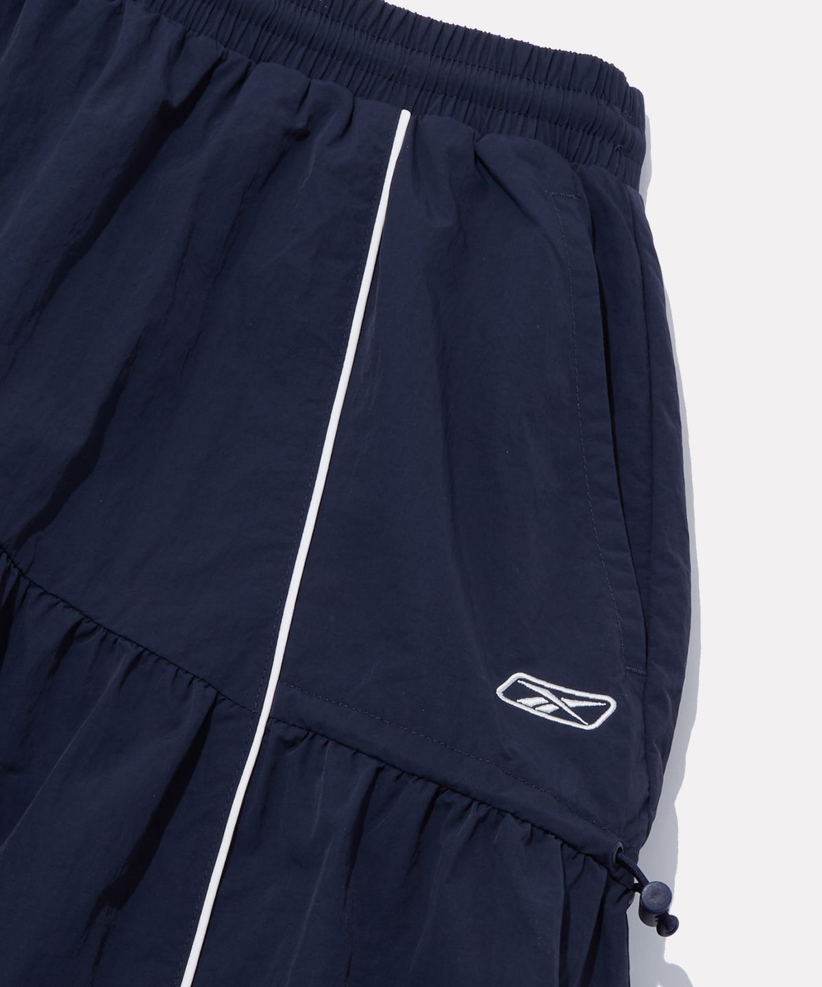 리복(REEBOK) 플레어 스트링 스커트 (W) - 네이비