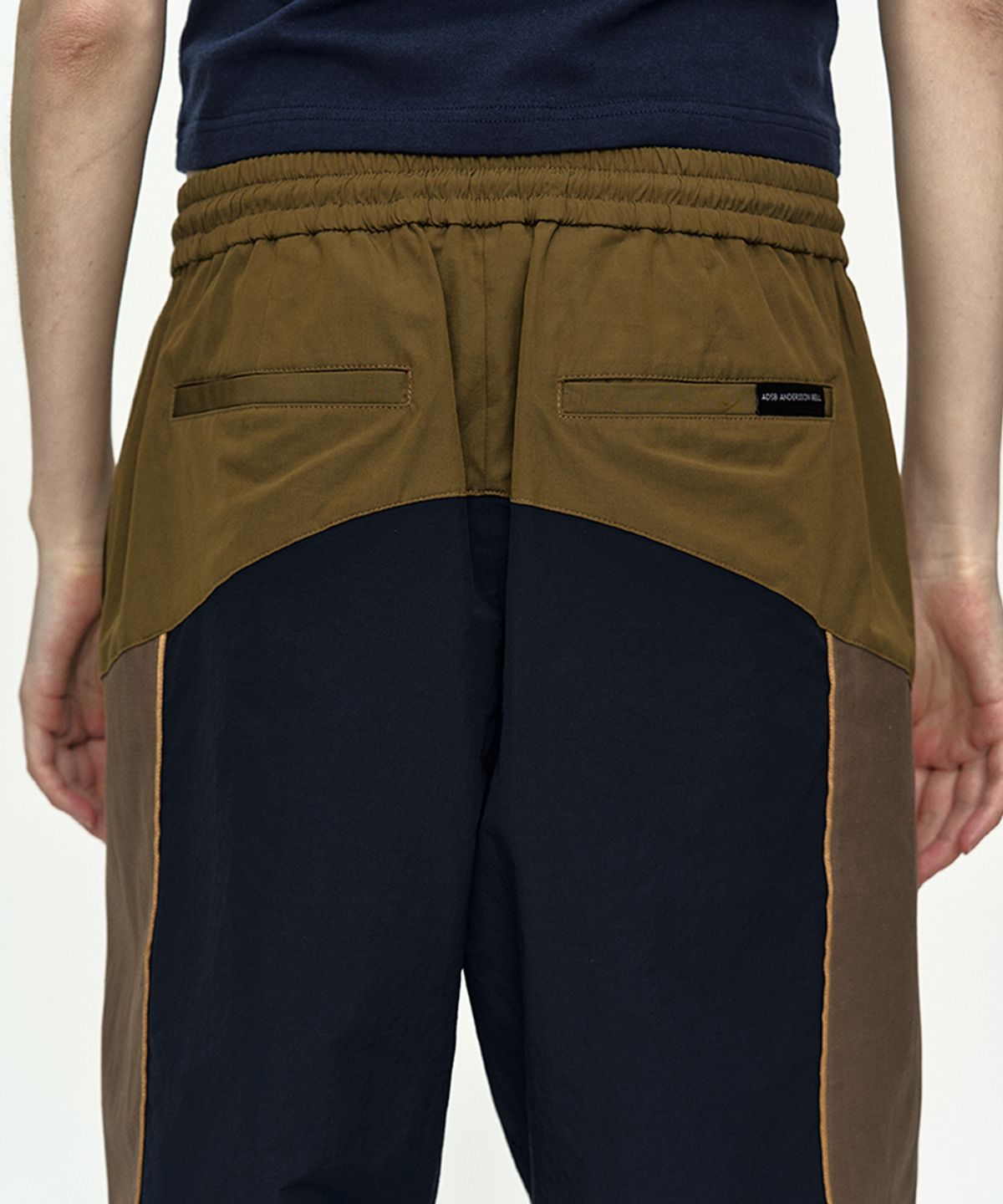 앤더슨벨(ADSB ANDERSSON BELL) UNISEX COLOR BLOCK NYLON TRACK PANTS apa876u(NAVY/KHAKI)