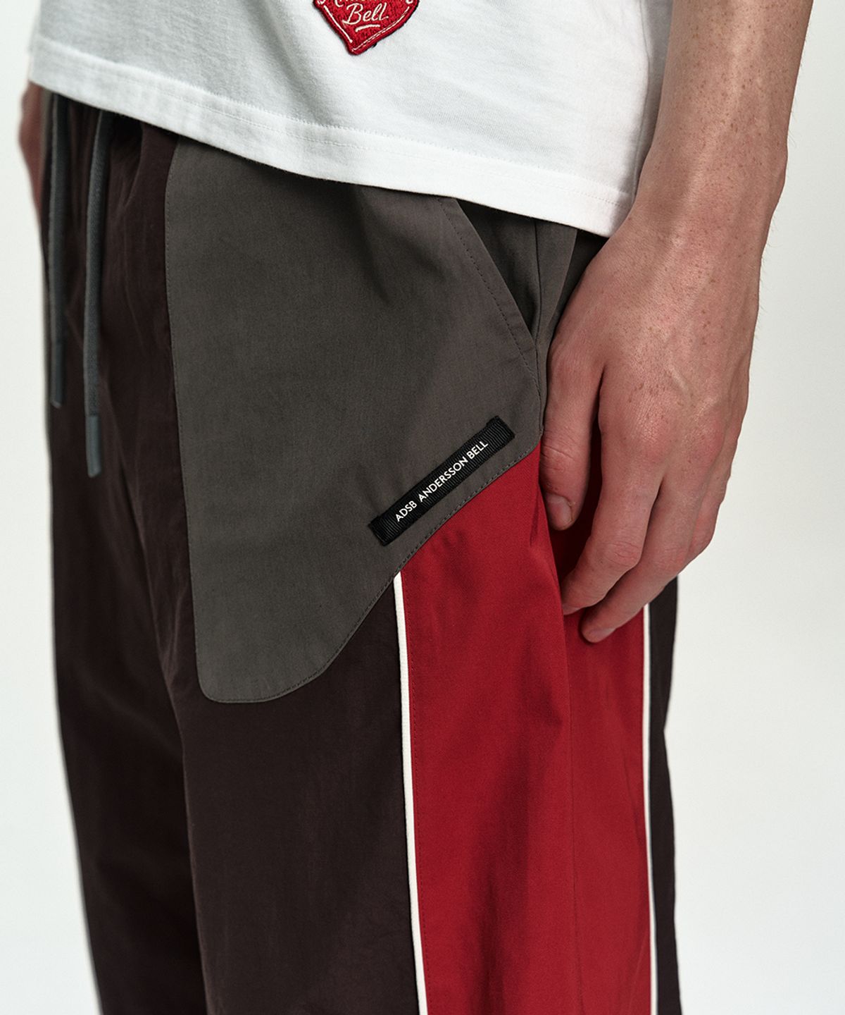 앤더슨벨(ADSB ANDERSSON BELL) UNISEX COLOR BLOCK NYLON TRACK PANTS apa876u(RED/BROWN)