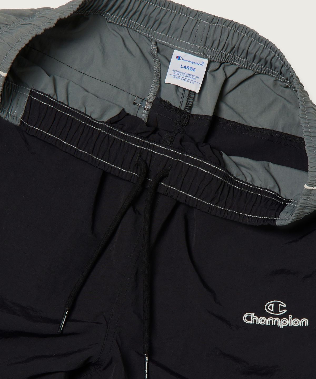 챔피온(CHAMPION) 트랙 로고 컬러블록 트랙 팬츠 Black