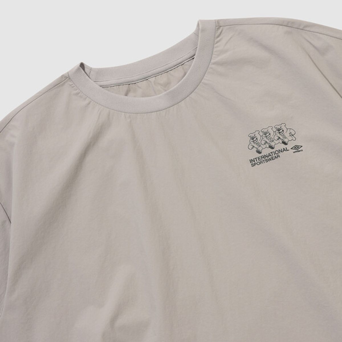 엄브로(UMBRO) 팝러쉬 더비독 그래픽 긴팔 피스테 베이지 UR121CWT35