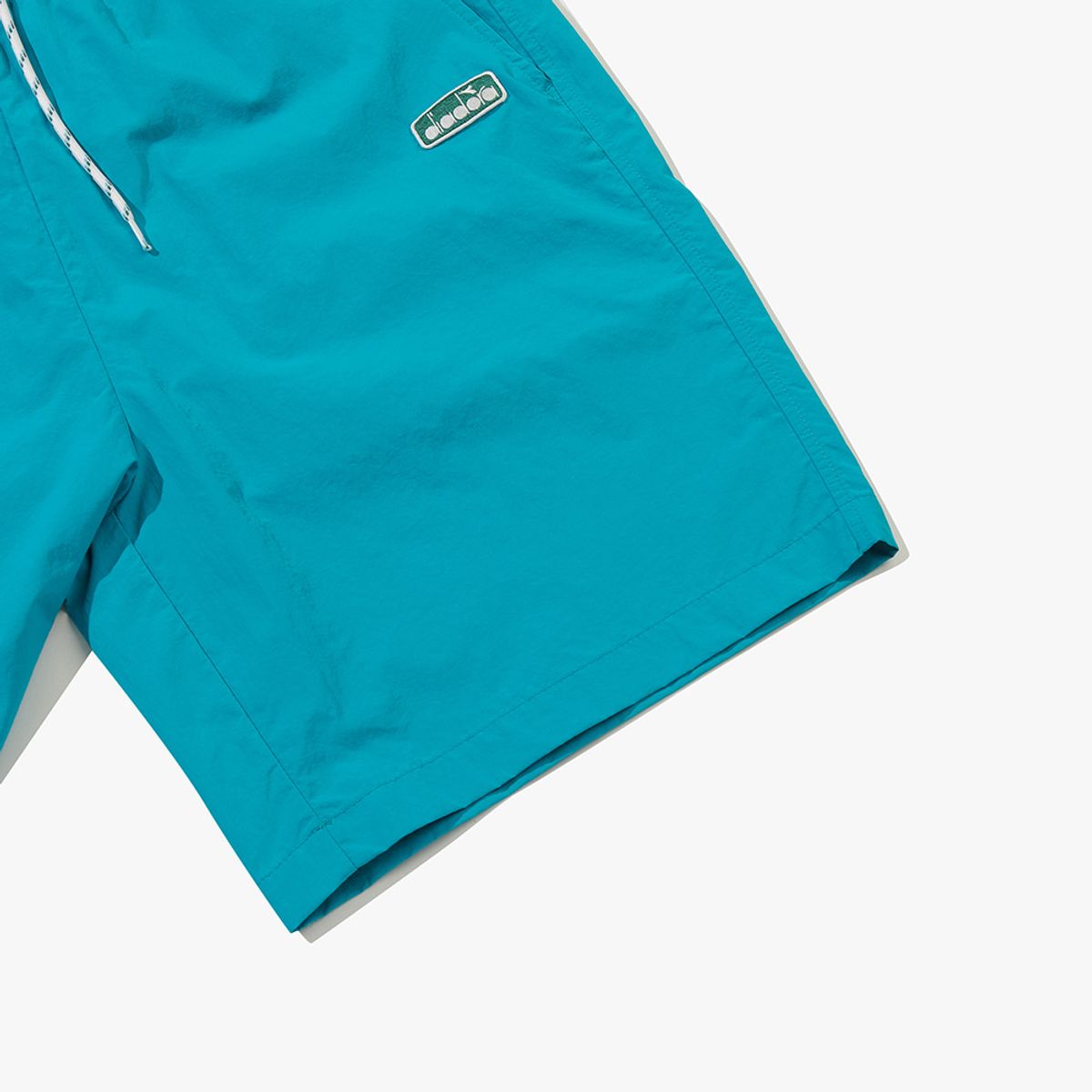 디아도라(diadora) 컴피 4부 우븐 쇼츠 TURQUOISE