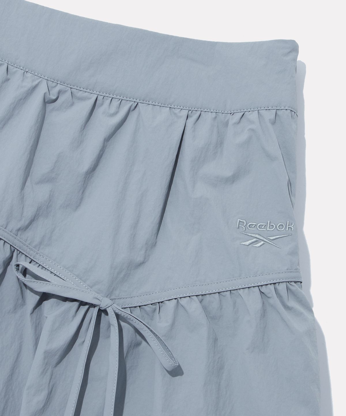 리복(REEBOK) 벌룬 셔링 미니 스커트 (W) - 세이지 그레이
