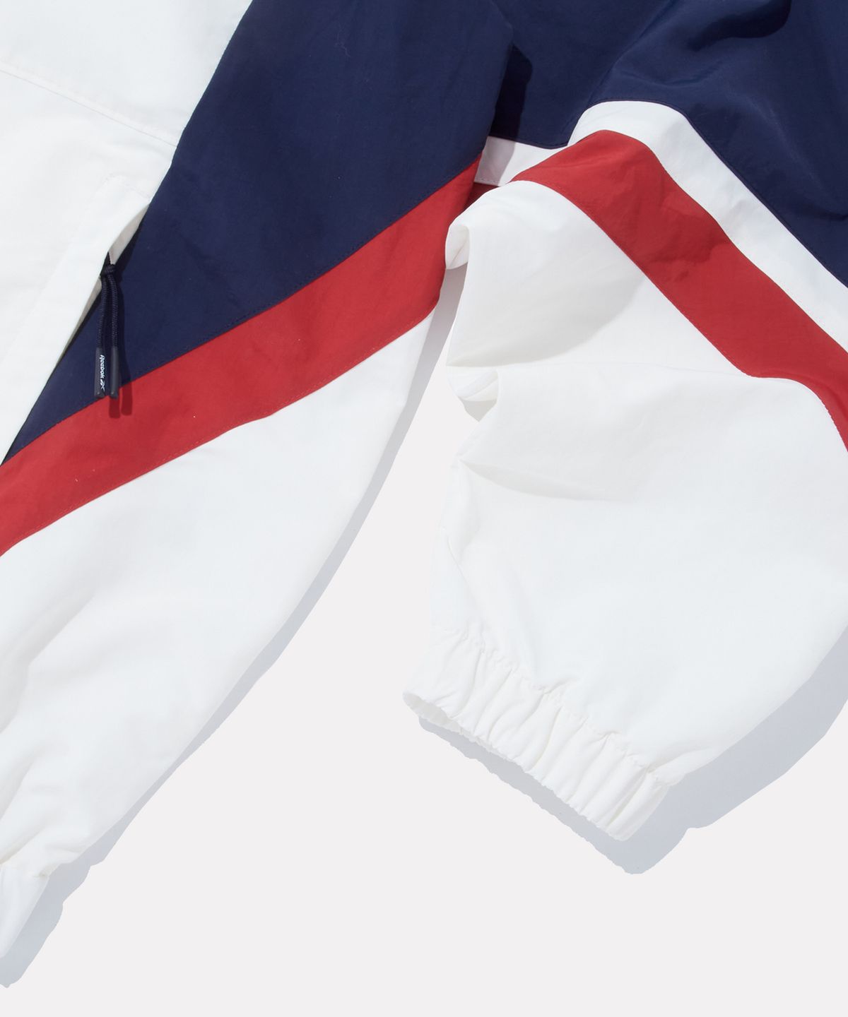리복(REEBOK) DNA 컬러블록 윈드브레이커 - 오프 화이트