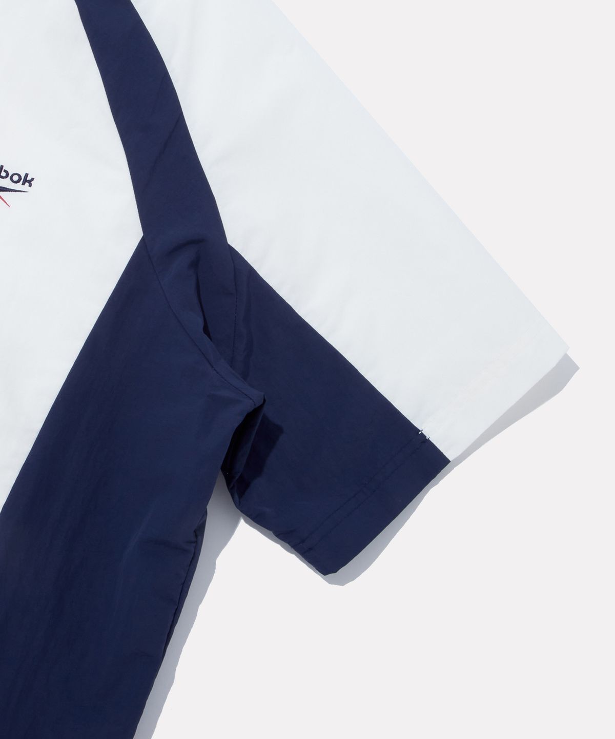 리복(REEBOK) DNA 컬러블록 반팔 아노락 - 화이트:네이비