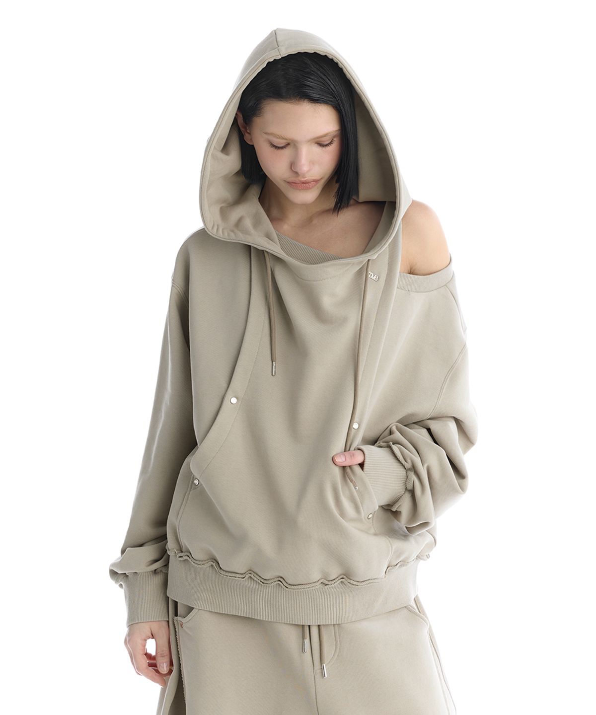 트리밍버드(TREEMINGBIRD) TMB One-Shoulder Raw Cut Set-Up Hoodie [ Beige ]