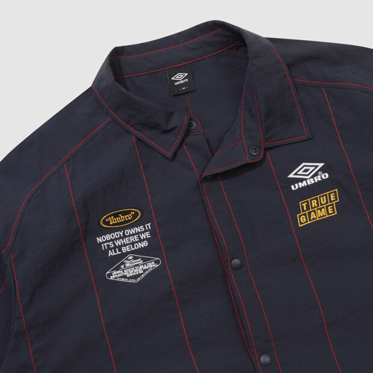 엄브로(UMBRO) 크리스피 타슬란 반팔 셔츠 네이비 UR221CJK58