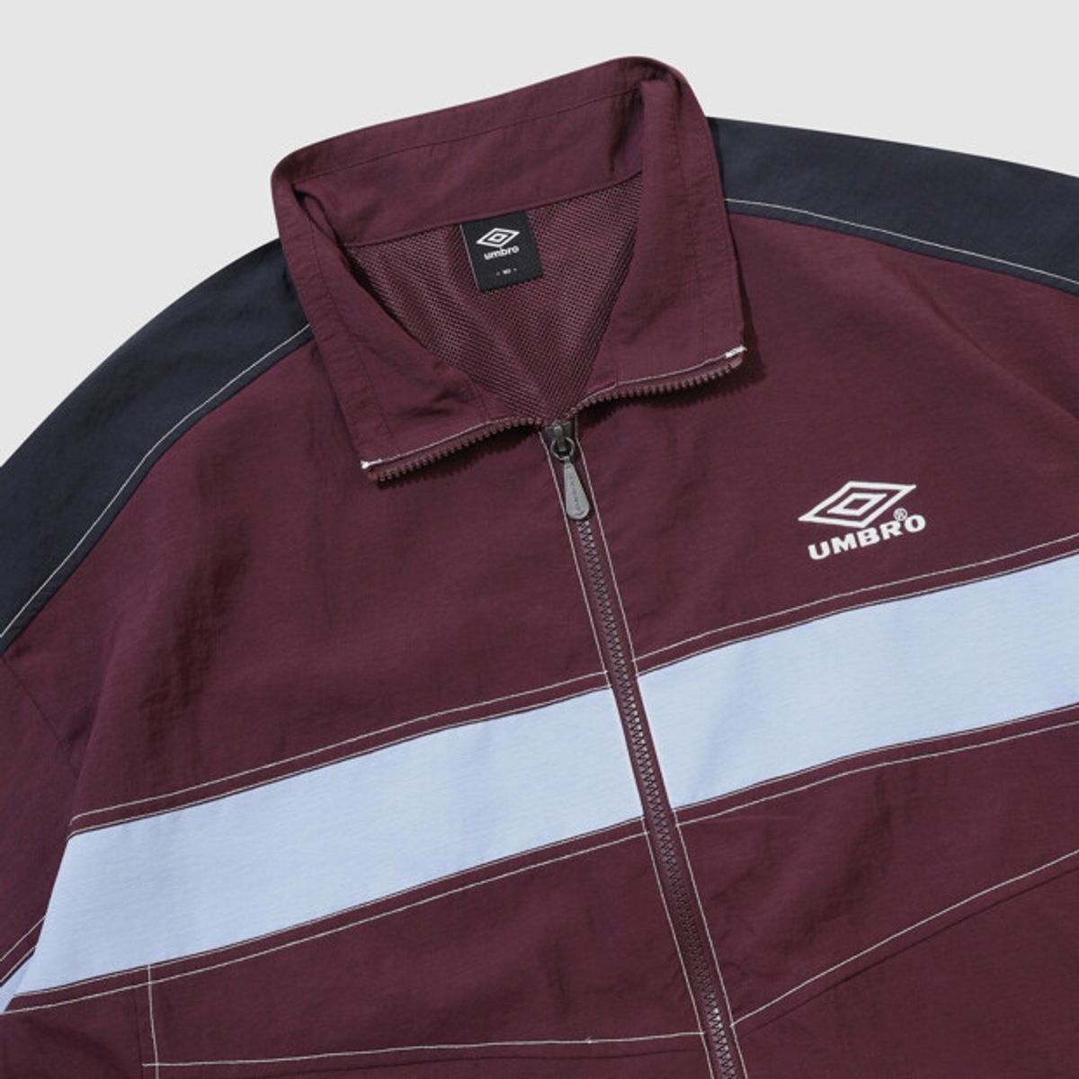 엄브로(UMBRO) 크리스피 타슬란 긴팔 바람막이 자켓 와인 UR224CJK59