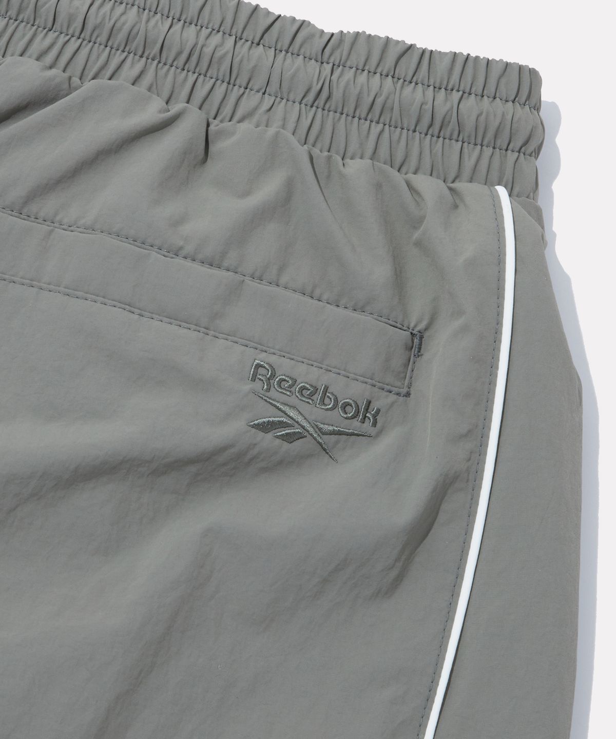 리복(REEBOK) 올커버 우븐 와이드 팬츠 (W) - 카키쉬 그레이