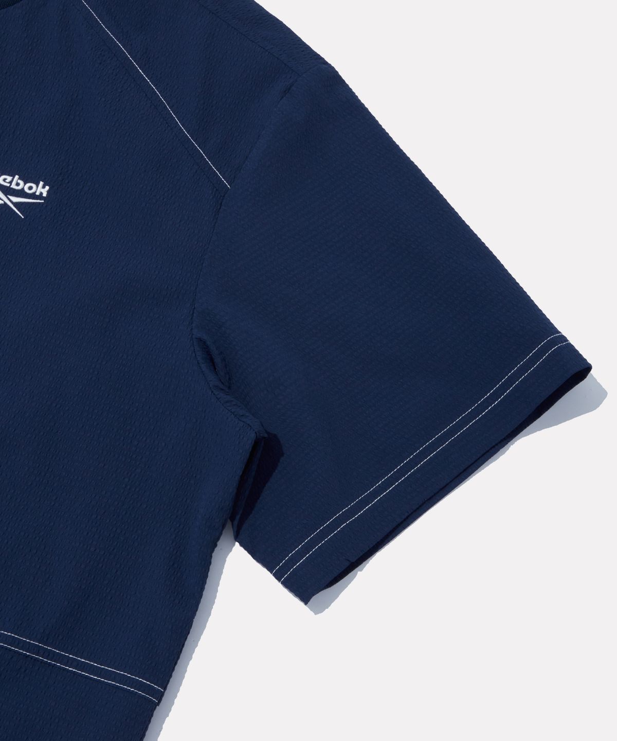리복(REEBOK) 시어서커 반팔 피스테 - 네이비