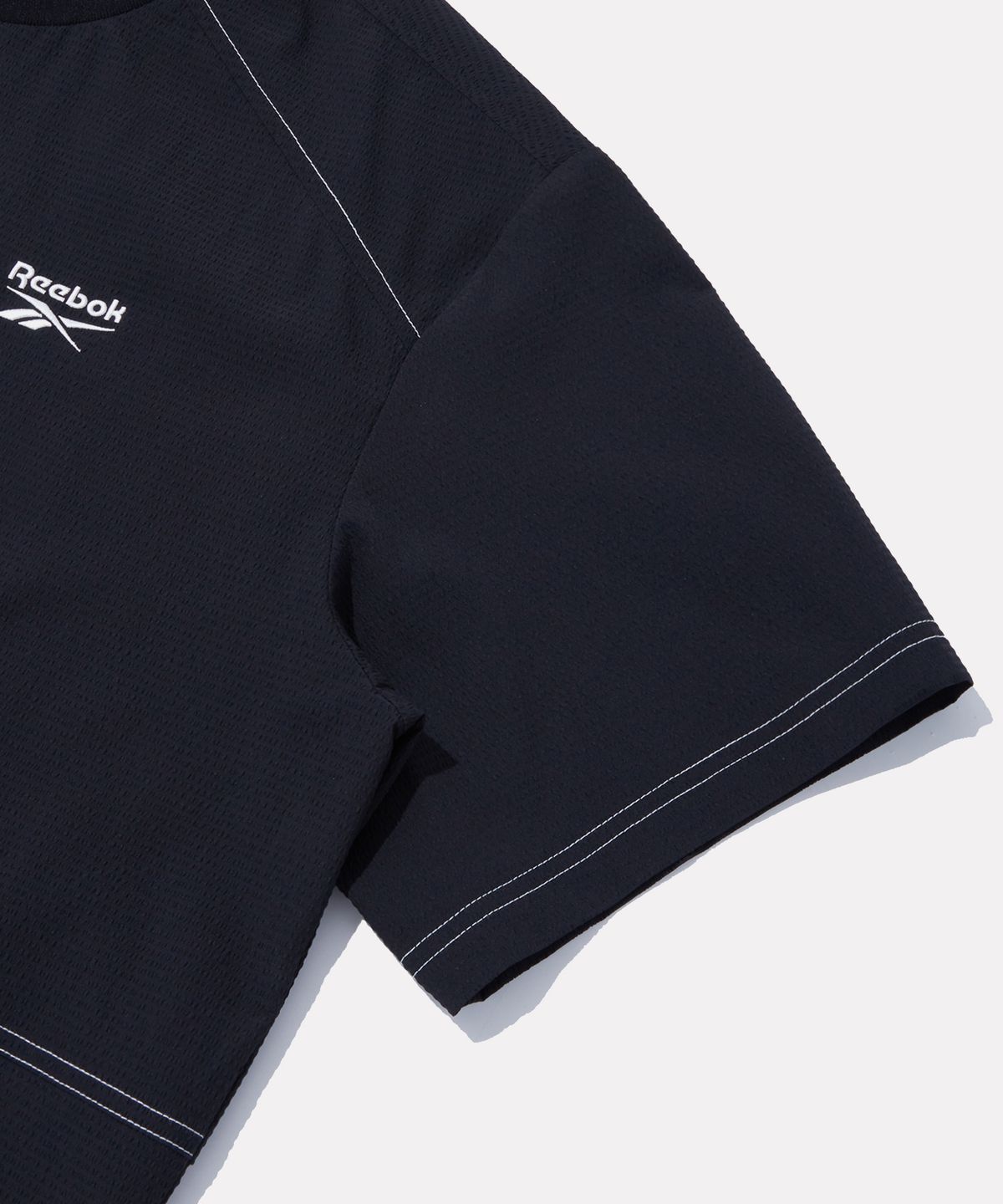 리복(REEBOK) 시어서커 반팔 피스테 - 블랙