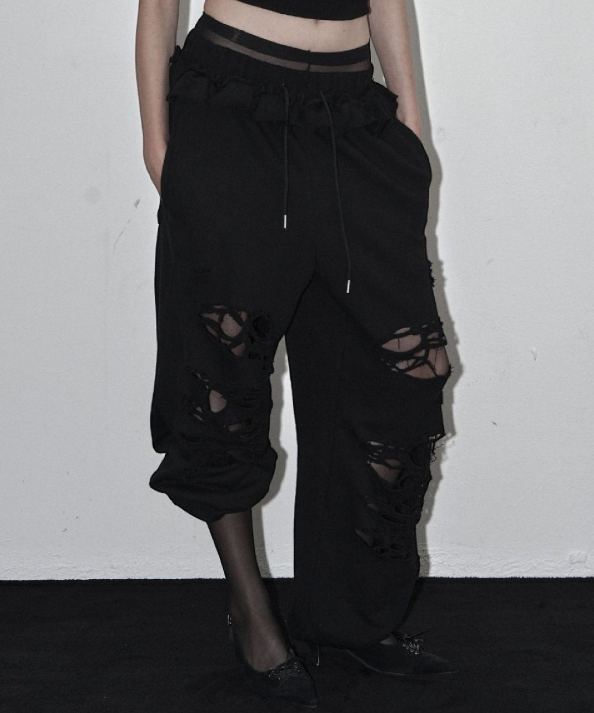 시너진(SYNERJYN) DISTRESSED FRILL SWEAT PANTS BLACK